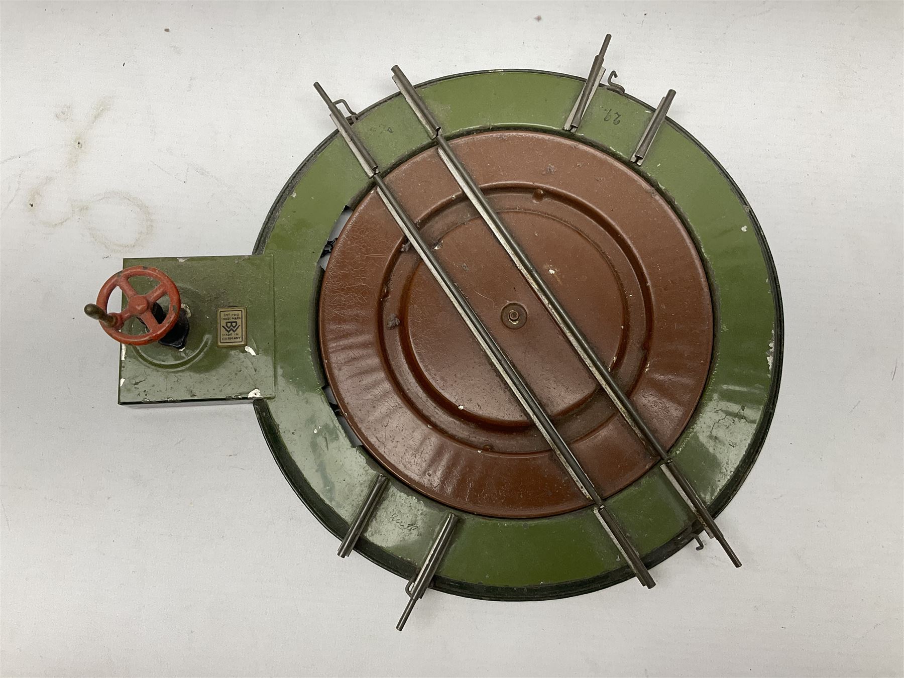 '0' gauge - Bing tin-plate two-storey double sided station with open walk-through to one end, rail side canopy, hinged doors and removable roof giving access to clock illumination L35cm; Bing hand-cranked turntable and open wagon; Marklin tin-plate level crossing barrier and Newspaper vendor's tin-plate four-wheel hand cart (5)