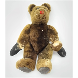 Mid-20th century plush covered teddy bear, the revolving head with applied eyes and stitched nose and mouth, on body with jointed limbs H54cm