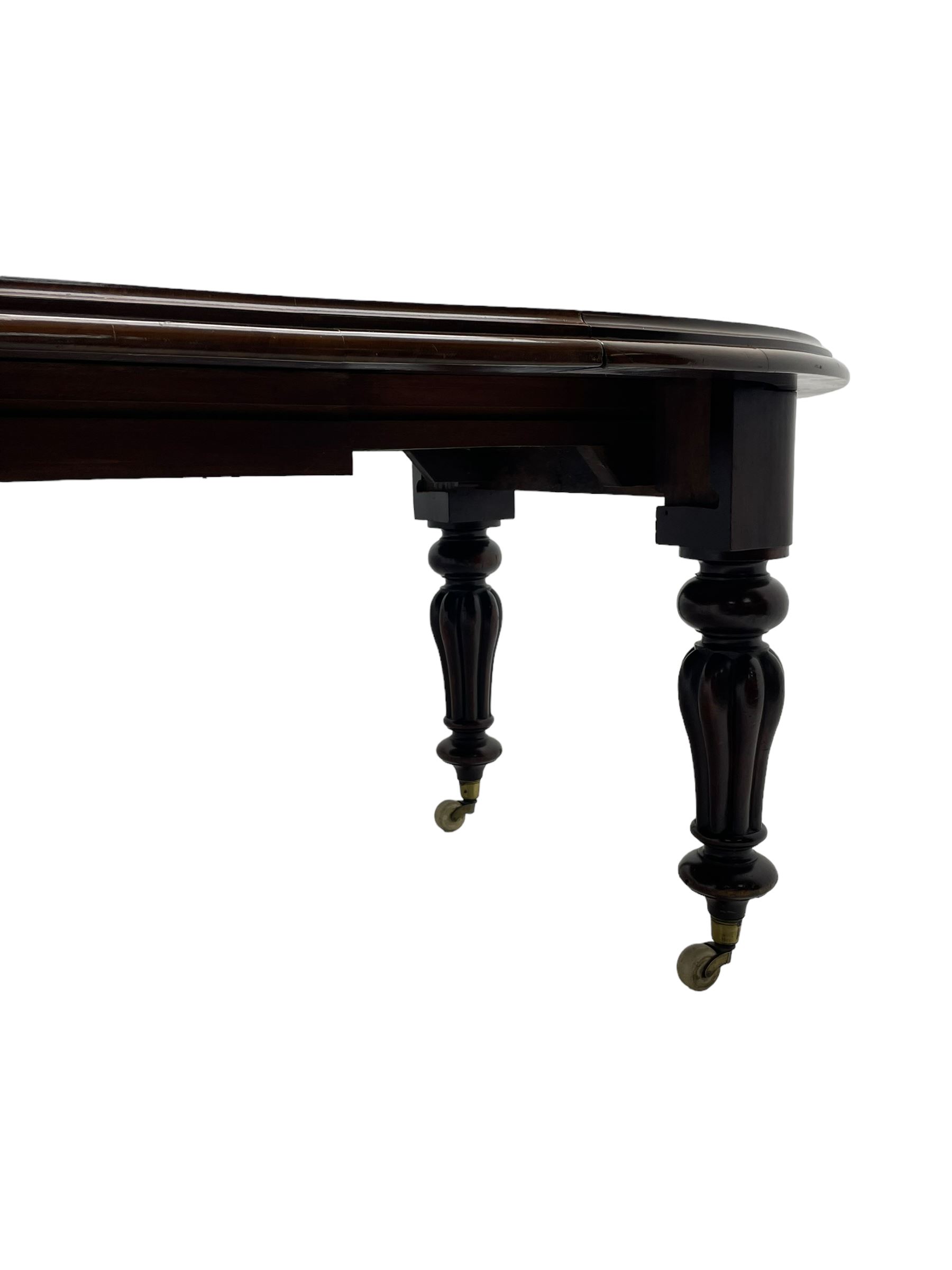 Victorian mahogany extending dining table, circular telescopic extending top with moulded edge, two additional leaves, on turned and lobe carved supports with brass and ceramic castors 