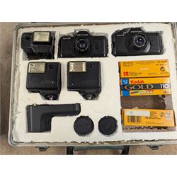 Two Pentax Auto 110 camera bodies and accessories including flashes, winder and lenses, all within two flight cases