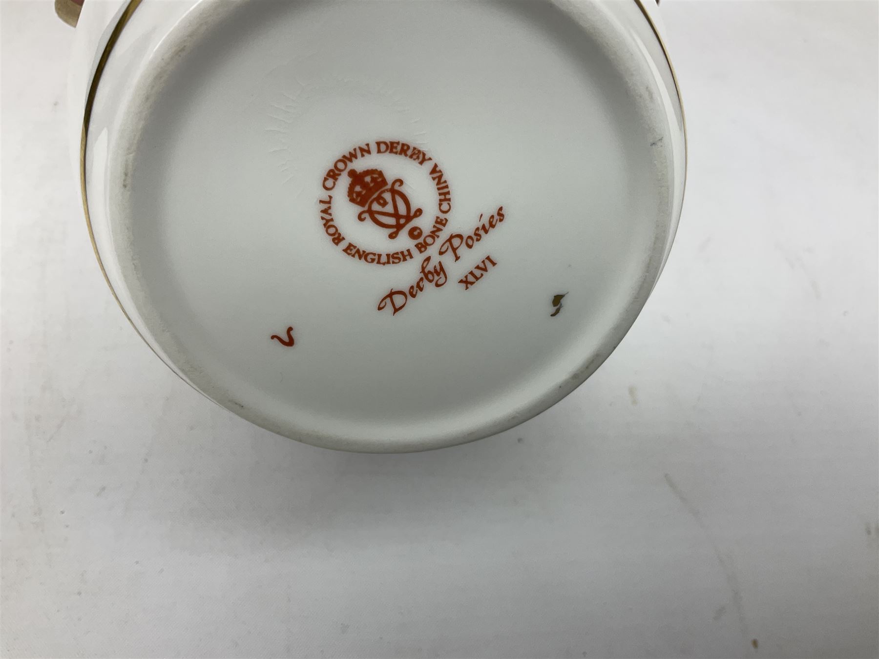 Royal Crown Derby paperweight in the form of a mallard duck, with gold stopper, together with Aynsley Orchard Gold lidded jar, bell, dish and plate, and Derby Posies pattern jar and cover, four with boxes