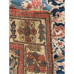 Persian Bidjar indigo ground rug, the busy field decorated with large floral motifs, the guarded ivory border adorned with repeating flower heads and stylised leaves