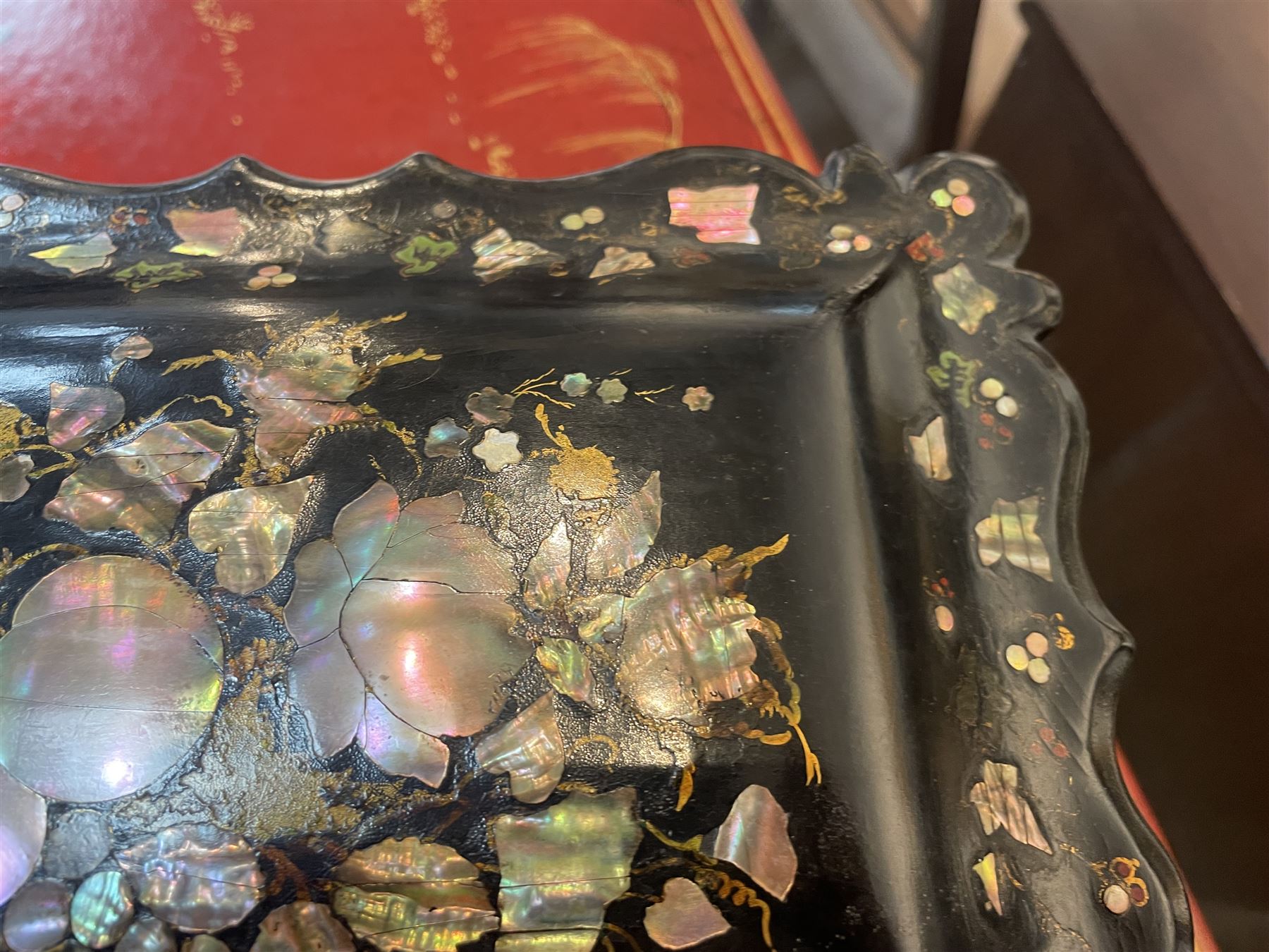 Victorian black lacquered papier-mâché sewing box, of rectangular form with shaped sides, the slightly domed top with inlaid mother of pearl and abalone decoration, the sides with gilt and polychrome painted scrollwork, the hinged cover opening to reveal a fitted interior with lift out tray, H14cm