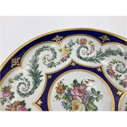 19th Sèvres style porcelain cup and saucer, the cup painted with a figural scene, against a scalloped border of scrolling floral swags on a blue ground, together with a Sèvres soft paste porcelain coffee can and saucer, painted with panels of exotic birds, roses and a border of cornflowers, LL monogram enclosing date letters H above painters mark, coffee can H6.5cm, saucer D13.5cm (2)