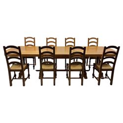 Oak extending dining table with elegant scrolled shaped double pedestal base and scrolled feet; together with a set of eight ladder back chairs with rush seats ((9) table closed 228x95x79cm chairs 106x38x44cm 