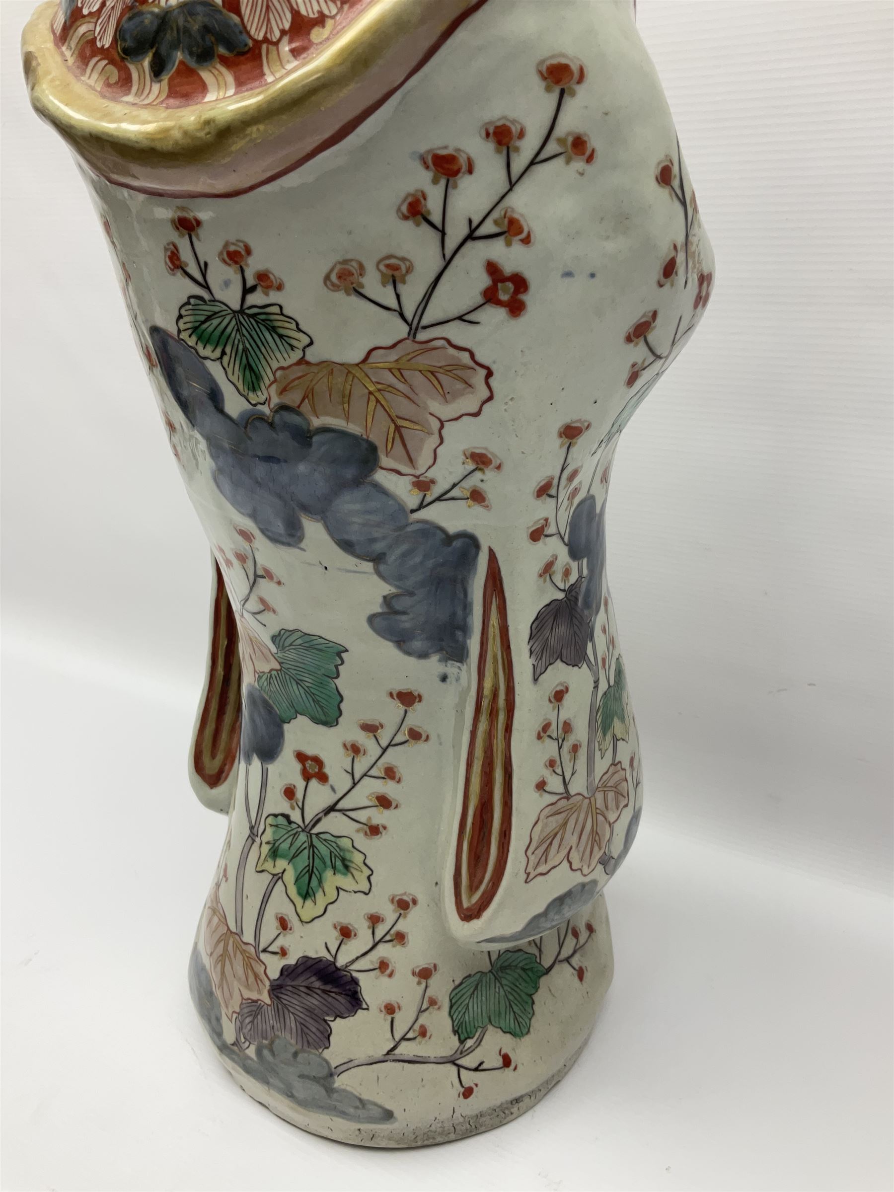 Large Japanese Imari porcelain figure, modelled as a Bijin, wearing a long kimono decorated with apple blossom and leafy branches on a white ground, with gilt detailing, possibly Edo period, H63cm