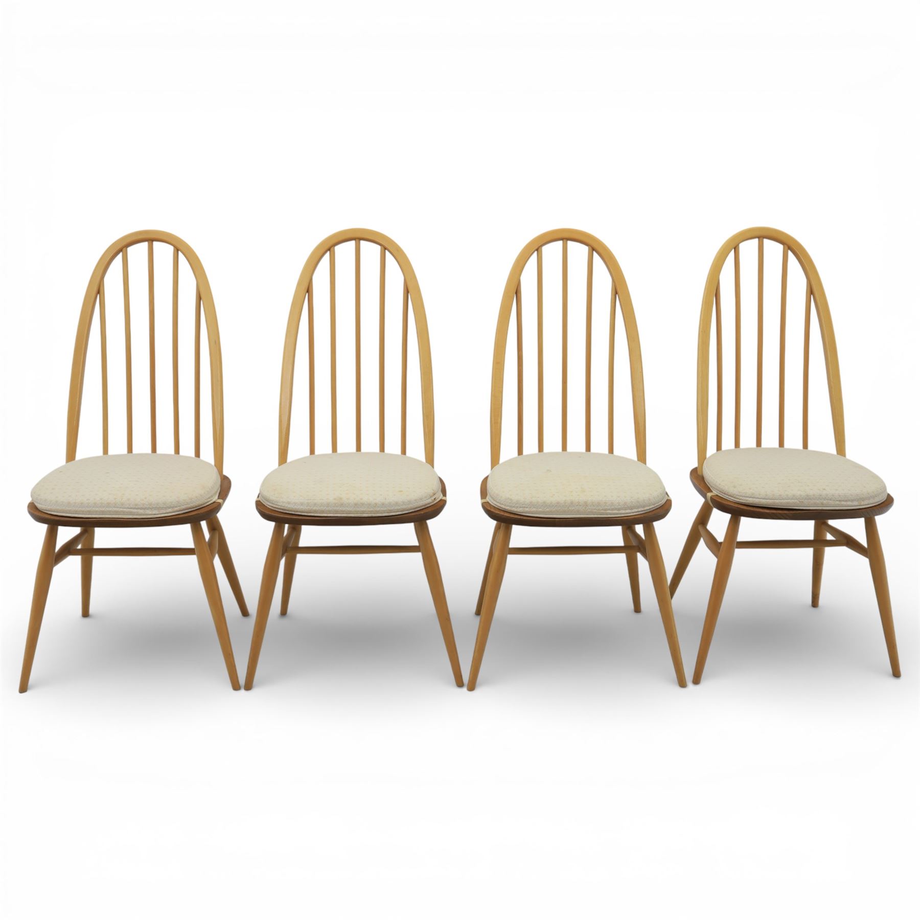 Ercol - elm dining chairs, set of six including two armchairs, arched spindle backs over shaped elm seats with upholstered pads, tapering beech legs joined by stretchers