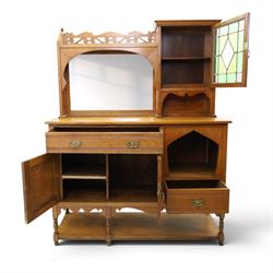 Maple & Co. - Arts & Crafts oak dresser with stained glass cupboard, raised section with pierced pediment above a mirrored back, with a stained glass fronted cupboard with fixed shelf, single long drawer, above a pair of fielded panels, with open recess above a short drawer, raised above a full length undertier with turned supports