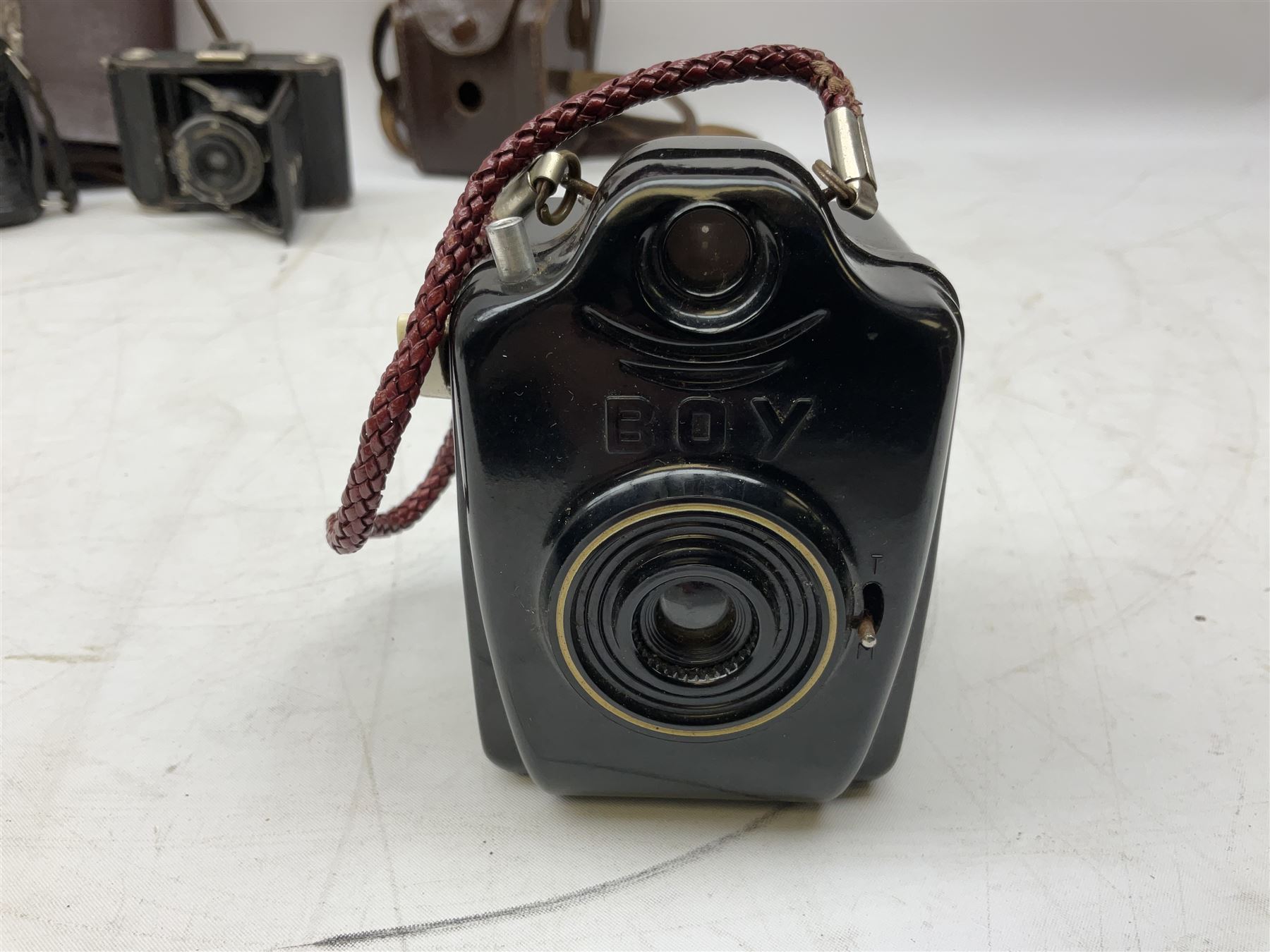 Bilora Boy Box Camera, with leather case, together with Zeiss Ikonta folding camera and another similar example 