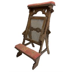 Late Victorian oak metamorphic prie-dieu chair, ecclesiastical design with pegged construction, upholstered kneel rest and top rest, hinged cane work seat