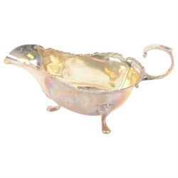 Edwardian silver sauce boat, of typical plain form with shaped rim, with flying C scroll handle and upon three pad feet, hallmarked Birmingham 1907, maker's mark worn and indistinct, together with a pair of Edwardian silver cruets, of urn form, upon three pad feet, hallmarked Horace Woodward & Co Ltd, Birmingham 1905 and a set of six silver apostle spoons, with matching sugar tongs and sugar sifting spoons, some hallmarked Miller Bros, London 1895 and Charles Boynton, all contained within fitted cases