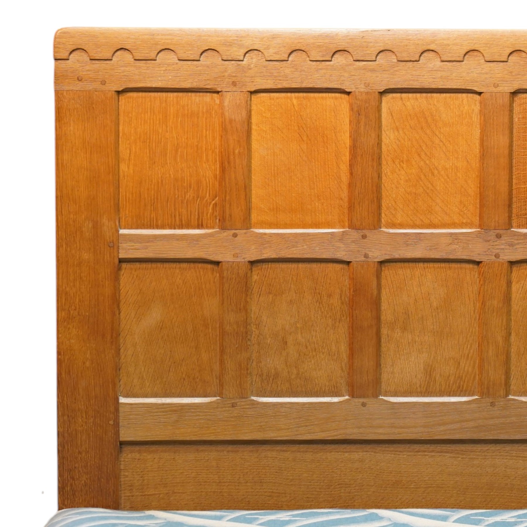 Mouseman - 4'6 panelled oak double bedstead, the head and footboard panelled with arcade carved cresting rails, with bed base and Vono metal rails, with carved mouse signature, by the workshop of Robert Thompson of Kilburn
