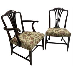 George III Hepplewhite design mahogany elbow chair and matching side chair, cresting rail carved with bellflowers over pierced and flared splat, seats upholstered in floral patterned fabric, raised on square tapering supports united by stretchers