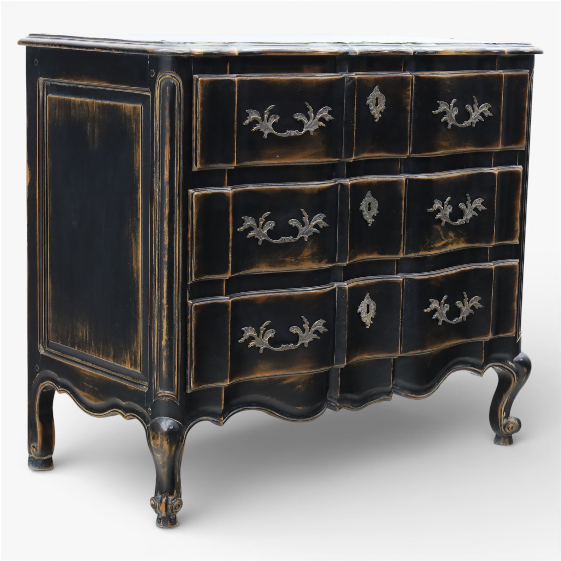 French style black lacquered chest of drawers, the serpentine front fitted with three graduated drawers mounted with scrolling foliate metal handles and key plates, shaped apron and scrolled cabriole legs