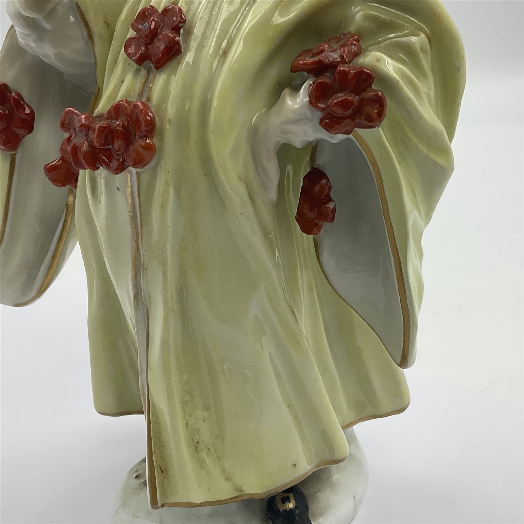 18th century Meissen figure of a Avvocato or the Lawyer from the Commedia Dell'arte series, circa 1740-45, modelled by J J Kandler, wearing gilt edged black tricorn hat, white mask, and yellow cape adorned with red rosettes, holding a scroll in his right hand, upon shaped oval base, no visible mark, H14.5cm