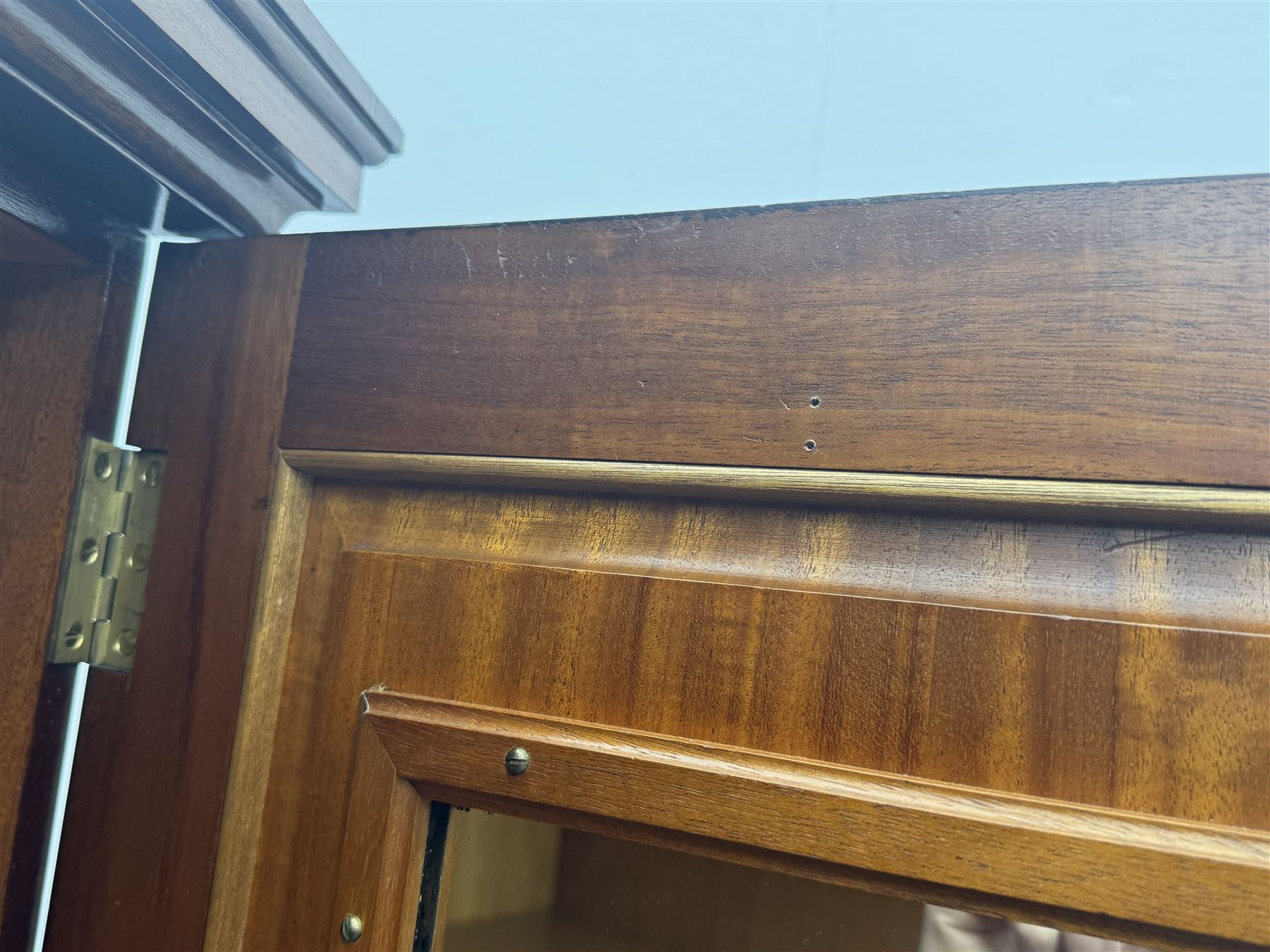 Wylie & Lochhead, Glasgow - early 20th century mahogany and satinwood double wardrobe, projecting cornice over panelled doors, interior fitted with mirrored door, shelves, drawers, hooks and hanging rail, raised on bracket supports with ceramic castors