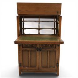 Old Charm - carved oak bar with three bar stools and associated Old Charm drinks cabinet, carved top with channels for glassware beneath, bar surface above glazed panels, shelves for glassware to the back, associated Old Charm drinks cabinet with fall front linenfold carving, above twin doors with shelved interior