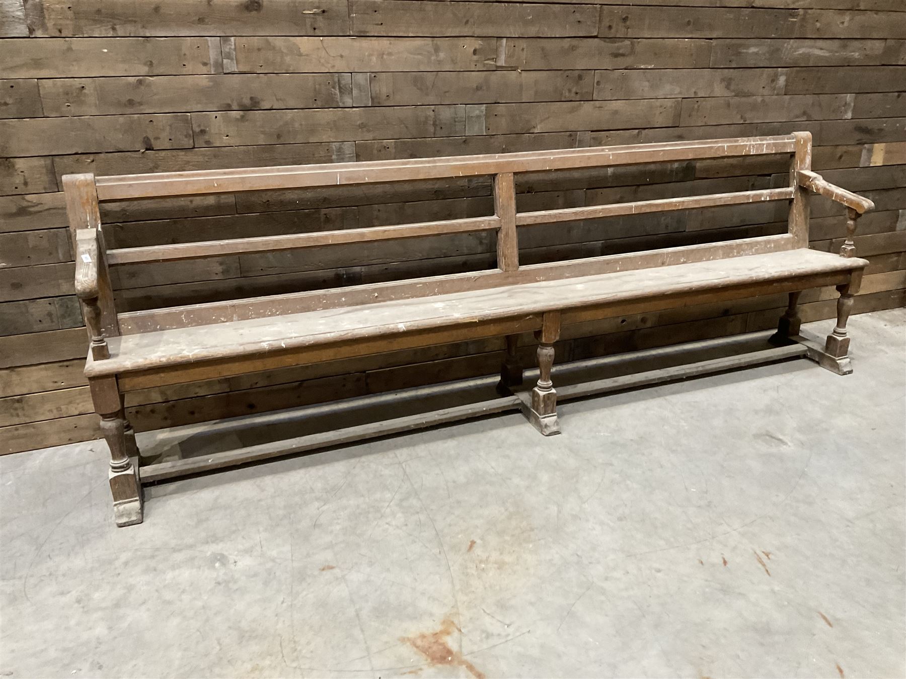 Victorian pitch pine bench pew, turned arms and legs, rail back with plank seat, 274cm