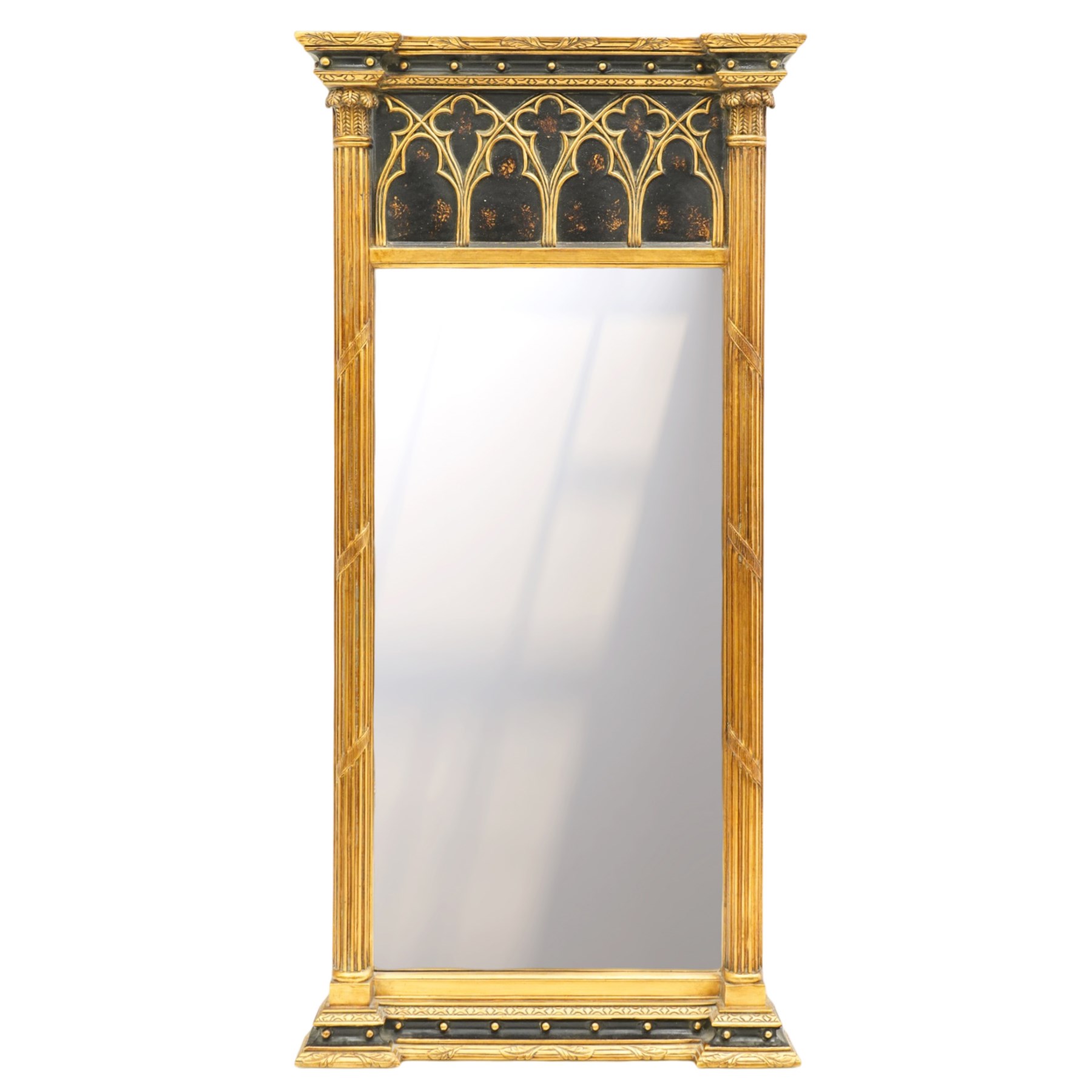 Tall Gothic Revival ebonised and gilt pier mirror, the projecting cornice with foliate ornament and applied spherical mounts, over a Gothic tracery frieze with trefoil motifs, the bevelled rectangular plate flanked by fluted Neoclassical columns with acanthus capitals, on a stepped ebonised and gilt plinth base with globular mounts
