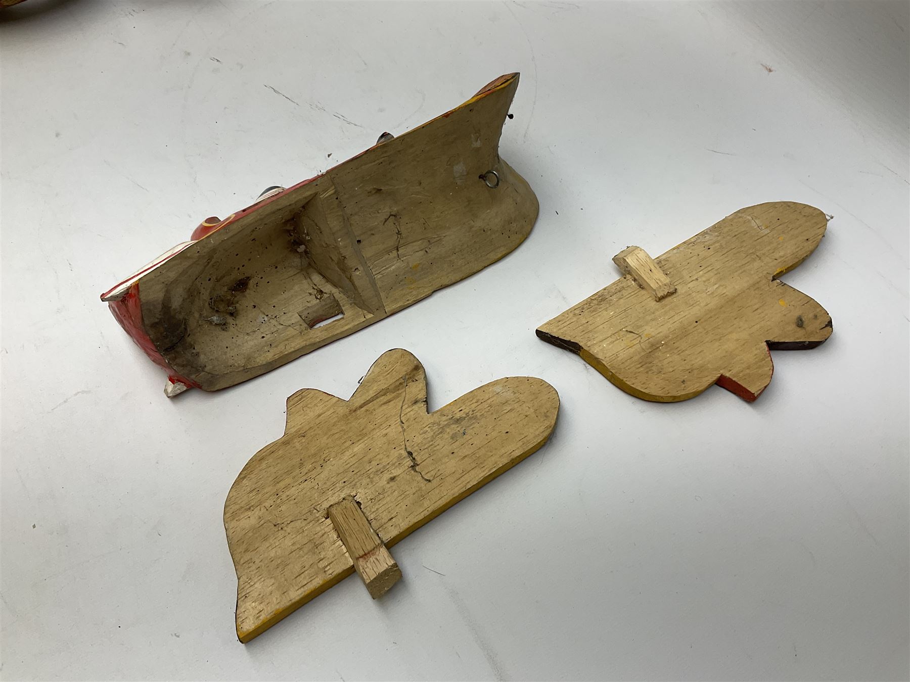 Sri Lankan Cobra mask depicting the demon Naga Raksha, together with a smaller example, largest H46cm