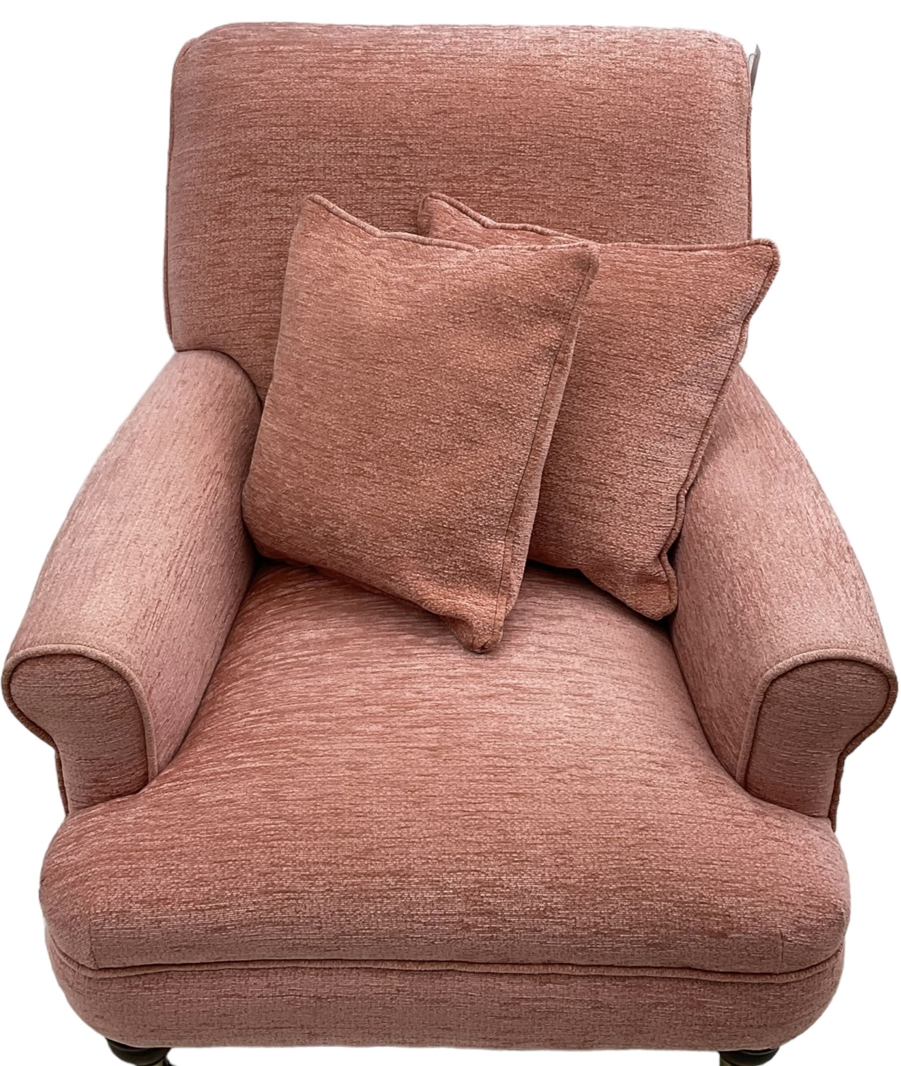Victorian design armchair, rolled back and arms, upholstered in salmon pink fabric with two scatter cushions (W77cm, H82cm, D94cm); matching rectangular footstool (60cm x 41cm, H28cm)
