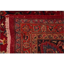  Fine quality Persian Meshed carpet, floral design on red ground field, repeating border, decorated with stylised flower heads, 390cm x 289cm  