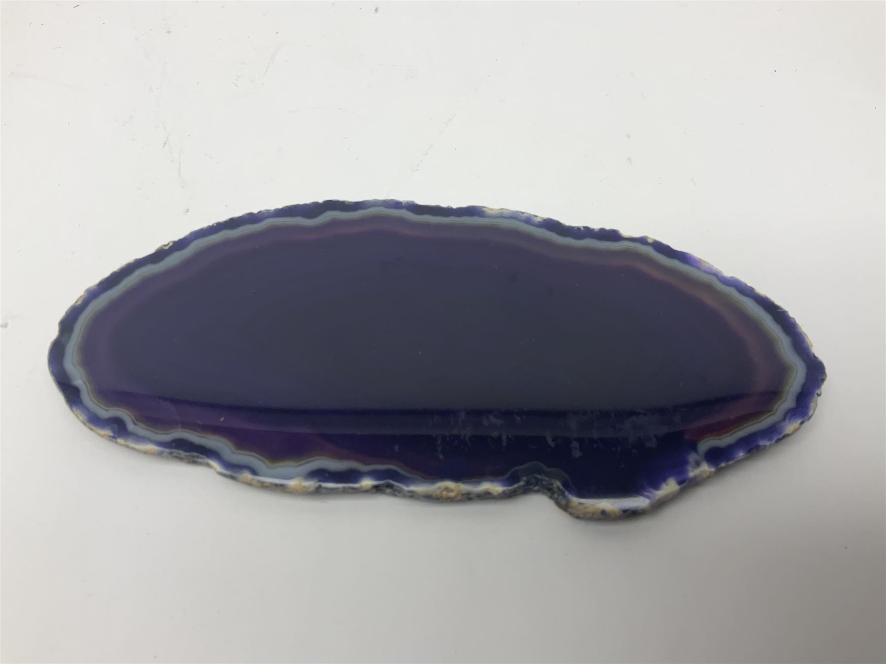 Four purple agate slices of various sizes, polished with rough edges