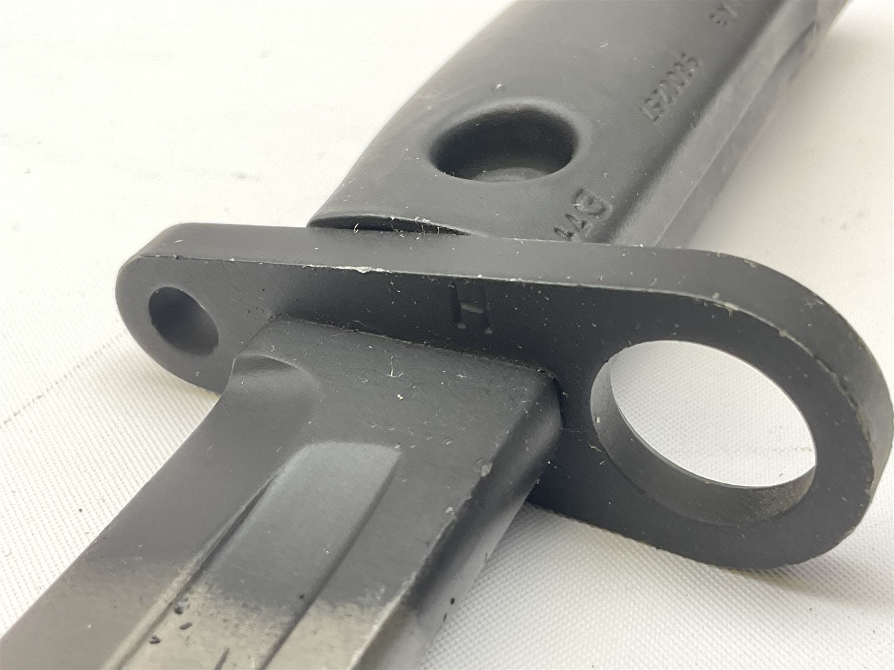 British Army L1A3 SLR Self Loading Rifle bayonet, with 20.5cm Bowie type fullered blade, hooked pommel with working push release button, grip secured by two deeply recessed rivets and marked L1A3 9600257 D71; in matching black scabbard L32.5cm overall