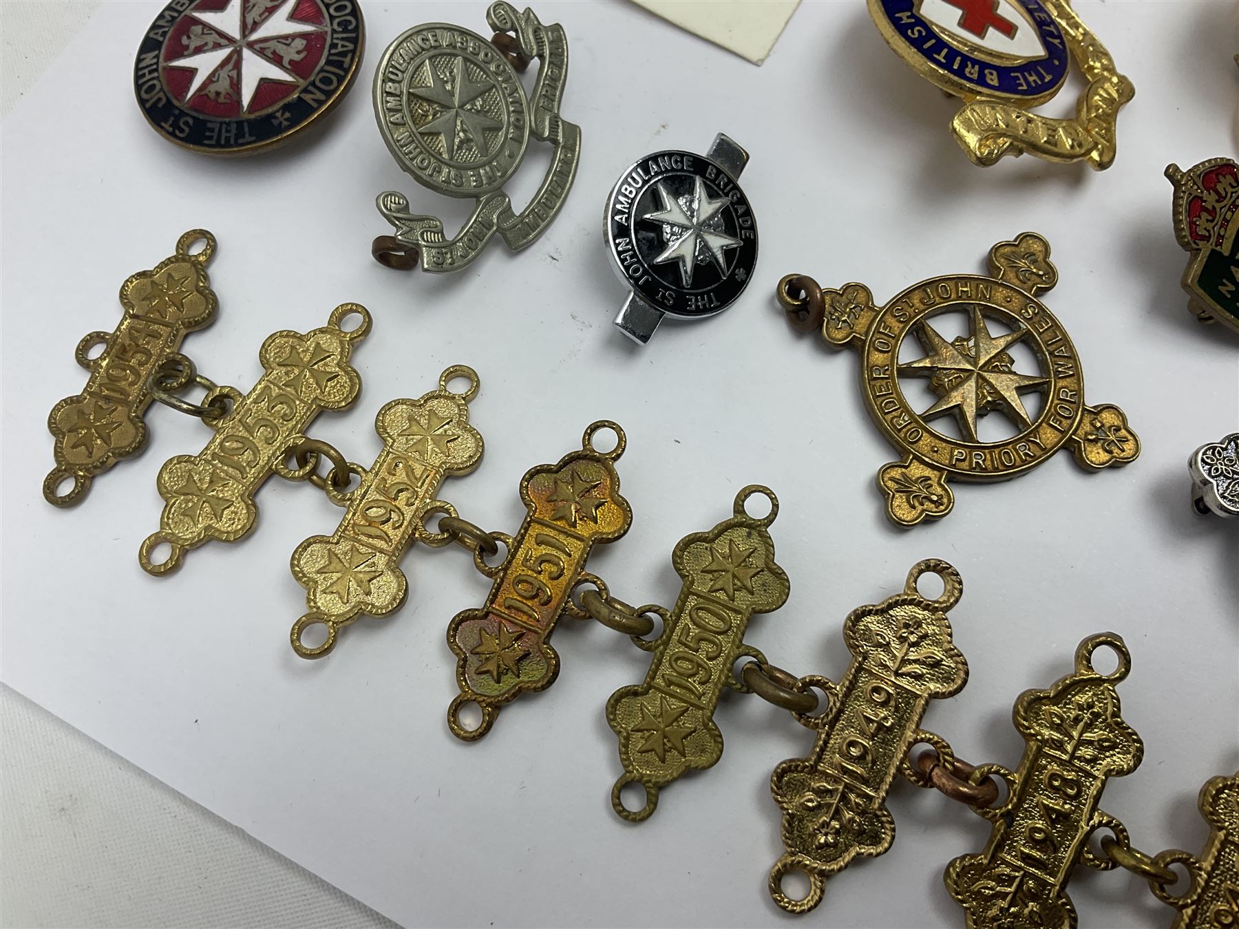 Collection of St John Ambulance enamel and metal badges, together with Red Cross medals and badges