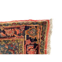 Persian Zanjan pale red ground rug, lozenge medallion and field decorated with floral Herati motifs, the border decorated with stylised plant motifs and trailing branches, floral pattern guard stripes