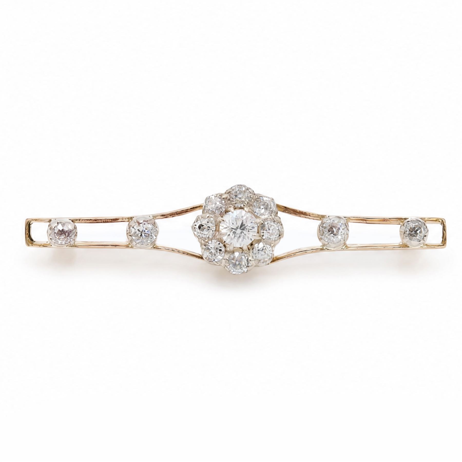Early 20th century gold and silver diamond brooch, the flower head cluster set with nine old cut diamonds, to split design shoulders, either side set with two further diamonds, total diamond weight approx 1.25 carat