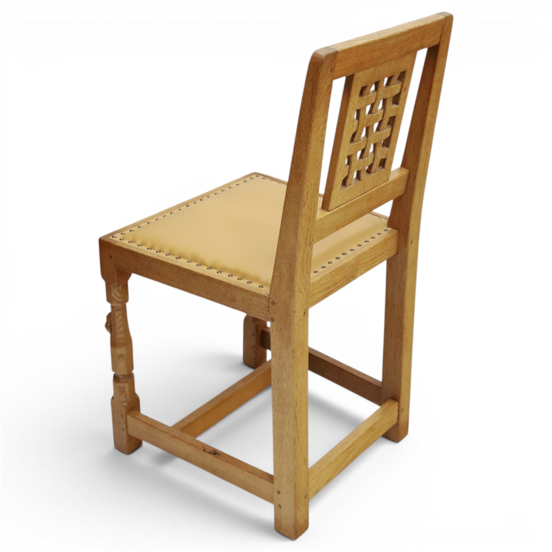 Mouseman - set of eight light oak dining chairs, each with lattice panel back and tan leather upholstered seat, raised on octagonal front legs joined by stretchers, with signature carved mouse, by the workshop of Robert Thompson, Kilburn