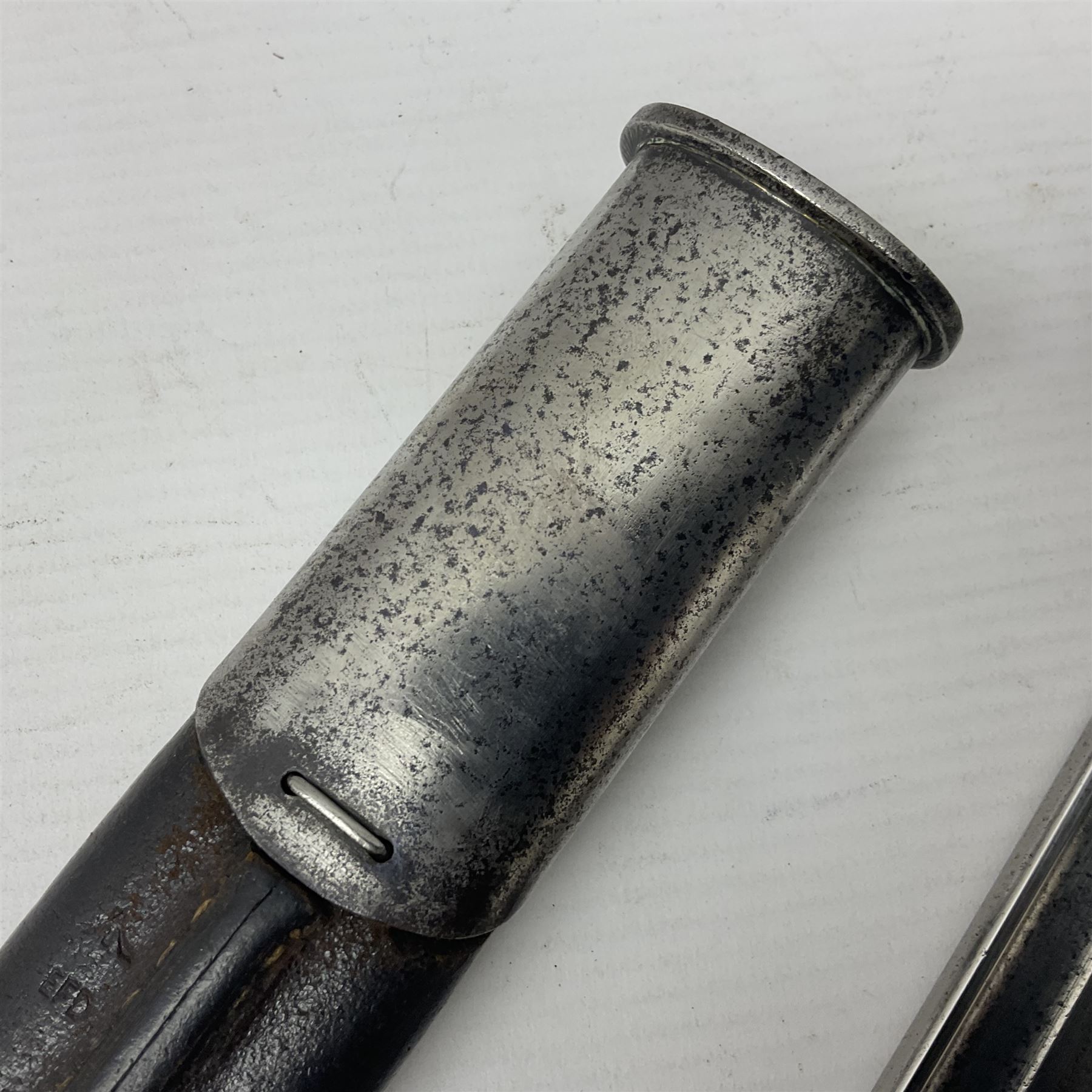 WW1 British pattern 1907 bayonet in polished condition with 43cm fullered steel blade by Sanderson, various marks to ricasso including date 12-14; in steel mounted leather covered scabbard L58cm overall