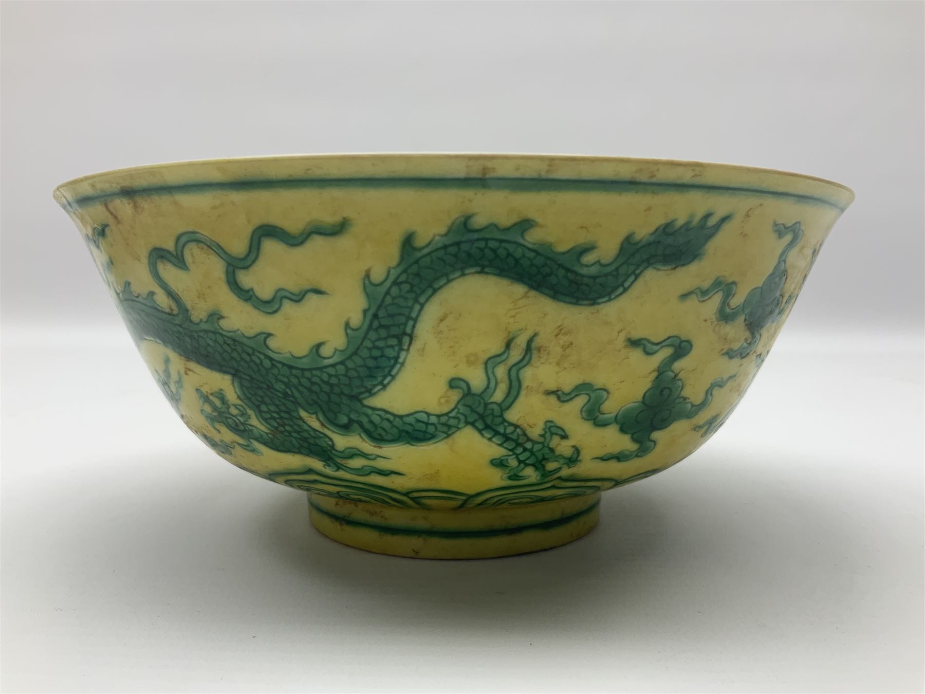 Pair of Chinese famille jaune bowls, decorated in green enamel with a dragon chasing a flaming pearl amongst clouds, upon a yellow ground, the interior decorated to centre with dragon, with six character mark beneath, D17.5cm
