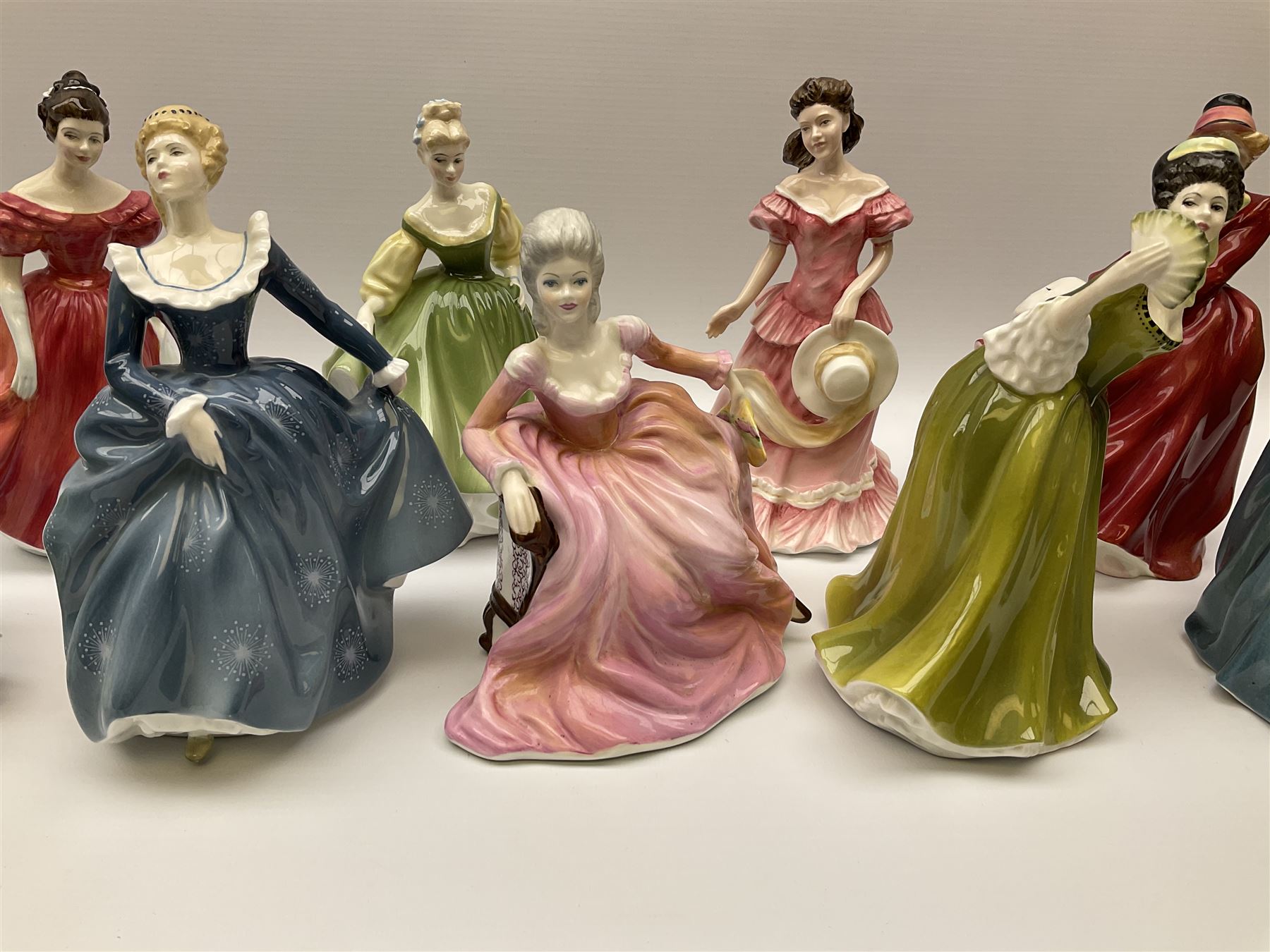 A group of eight Royal Doulton figures, comprising Simone HN2378, Amy HN3854, Fragrance HN2334, Louise HN3207, Adrienne H2304, Michele HN2234, Fine Lady HN2193, Winsome HN2220 and a Coalport figure, Polly. 
