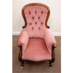  Victorian mahogany framed salon armchair, upholstered in a deep buttoned salmon fabric, cabriole legs on castors, W65cm  