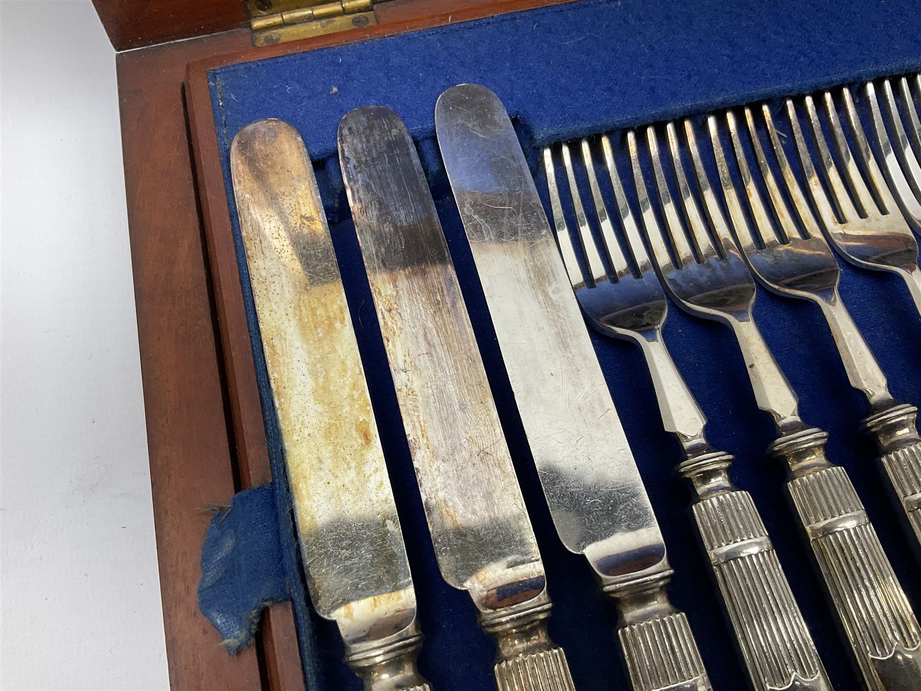 Victorian silver plated dessert set by Elkington & Co for twelve place settings, each reeded handle with vacant cartouche, each with Elkington & Co mark, date letter for 1861, and registration lozenge, contained within a mahogany case with vacant brass cartouche to the hinged cover, opening to reveal a Royal blue baize lined interior with removable tray, case H6cm W29.5cm D26.5cm
