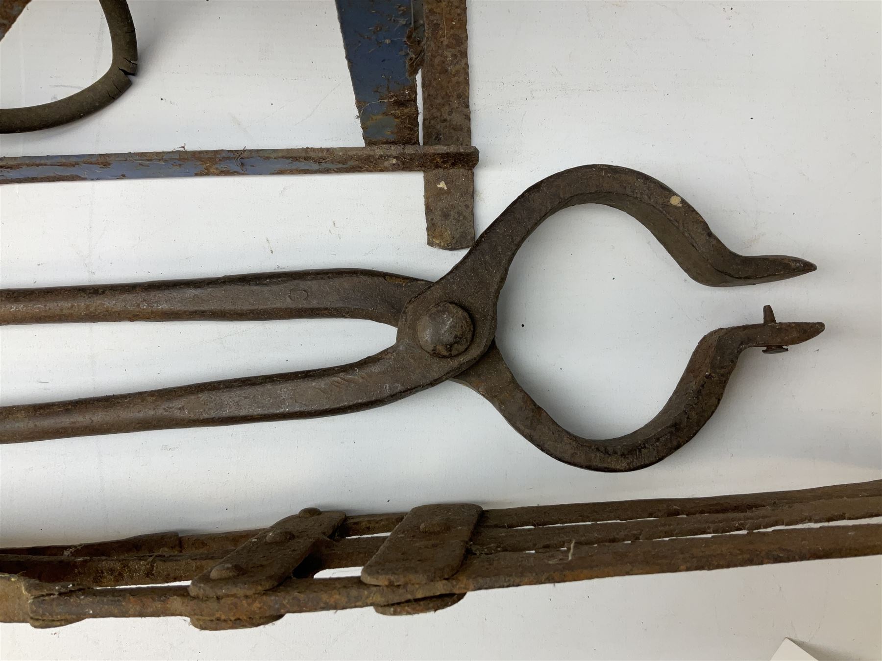 Blue and red painted gas powered bird / pest scarer, bearing label 'Exid bird & pest scarer, imported by C.R.E.A.C.O Hadleigh, Essex', , copper and brass Cymag gas hand pump, three eel spears and a set of badger tongs. Auctioneer's Note: These traps are sold as artefacts for ornamental purposes only as the use of some of them is illegal.