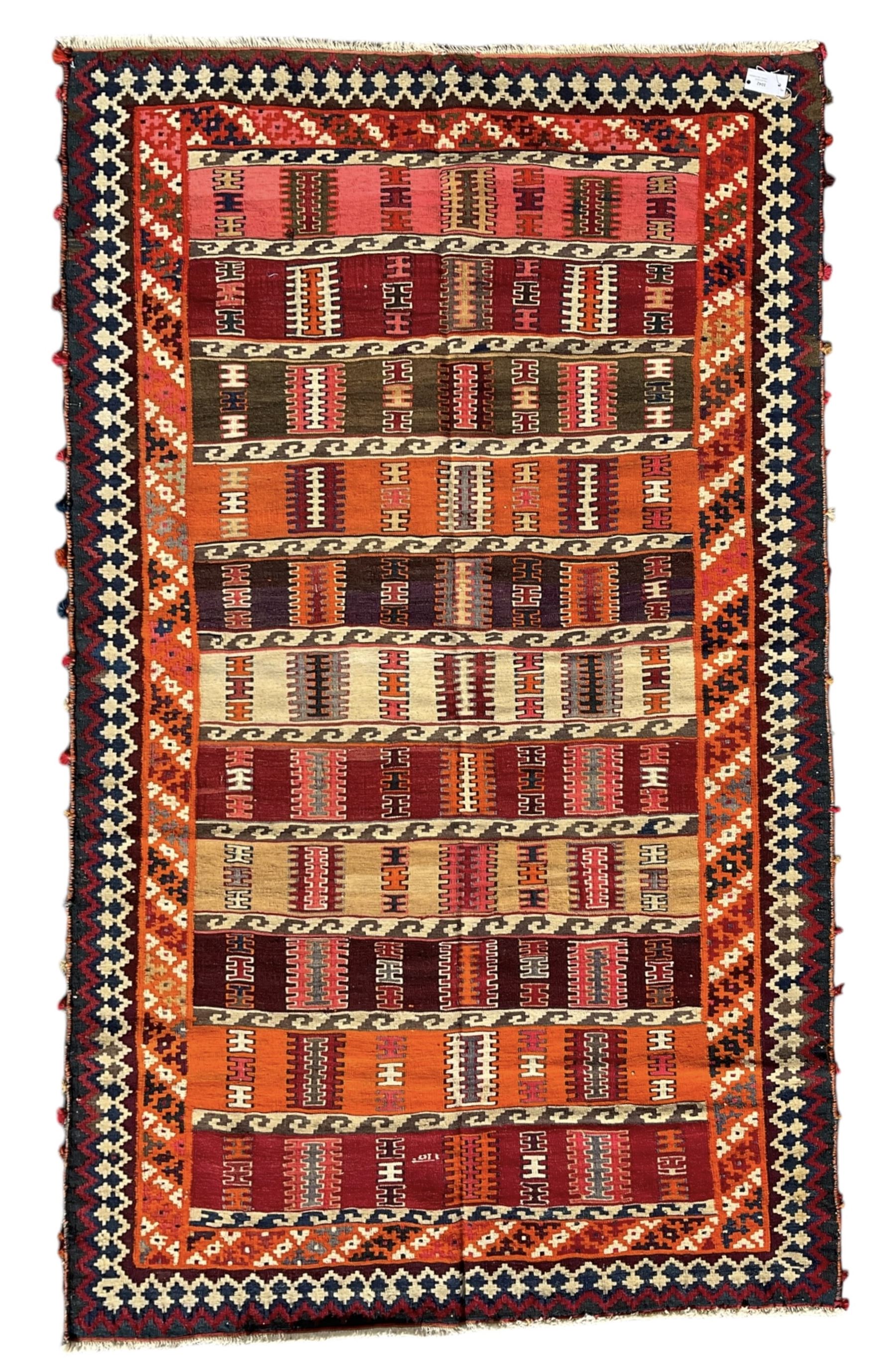Southwest Persian Qashqai Kilim ground rug, featuring a series of horizontal striped panels each filled with intricate geometric designs, enclosed by a dark blue and ivory border with stylised star and zigzag motifs