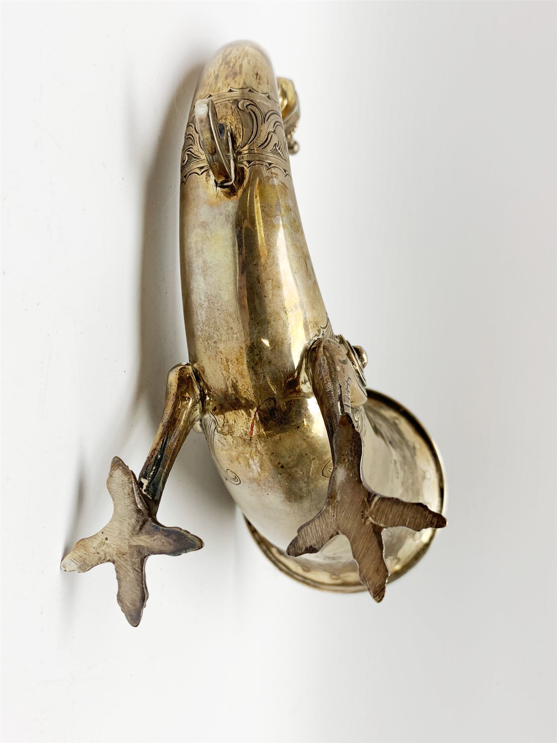 Late 19th century Danish silver drinking horn and cover, the body with hexagonal and beaded finial, raised upon two talon feet and further scroll foot, chased with scrolling foliate and zoomorphic bands, the detachable domed cover with conforming decoration surmounted by a figure holding a hammer, the cover interior impressed with maker's mark (partly worn and indistinct), alongside Danish Three Towers mark for 1881, with the Assay Master mark for Simon Groth (1863-1904), H23.5cm, weight 14.75 ozt (459 grams)

