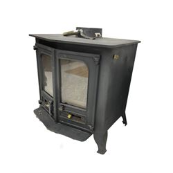 Cast iron stove, pointed arch front and enclosed by two doors, 