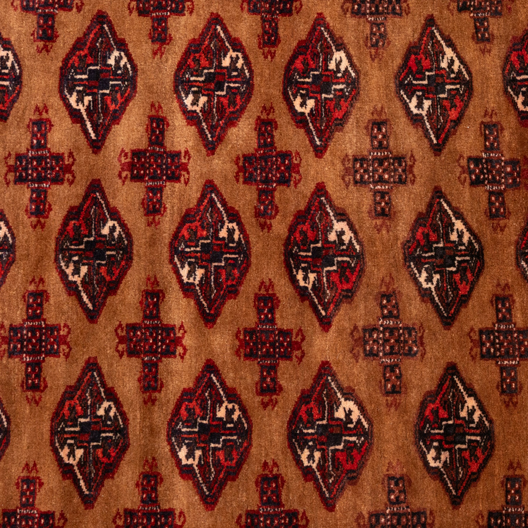 Afghan Bokhara dark amber and terracotta ground rug, decorated with Hac and Gul motifs  within multiple geometric guard bands