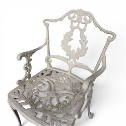 Victorian design cast aluminium garden table and twin armchairs featuring a pierced floral wreath splat, over a stylised scrolling acanthus leaf seat, including parasol