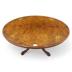Victorian inlaid burr-walnut and marquetry oval centre table, quarter veneered tilt-top with scrolling foliate and floral marquetry reserves on a turned carved column with clustered supports raised on four out-swept scroll legs on ceramic castors  