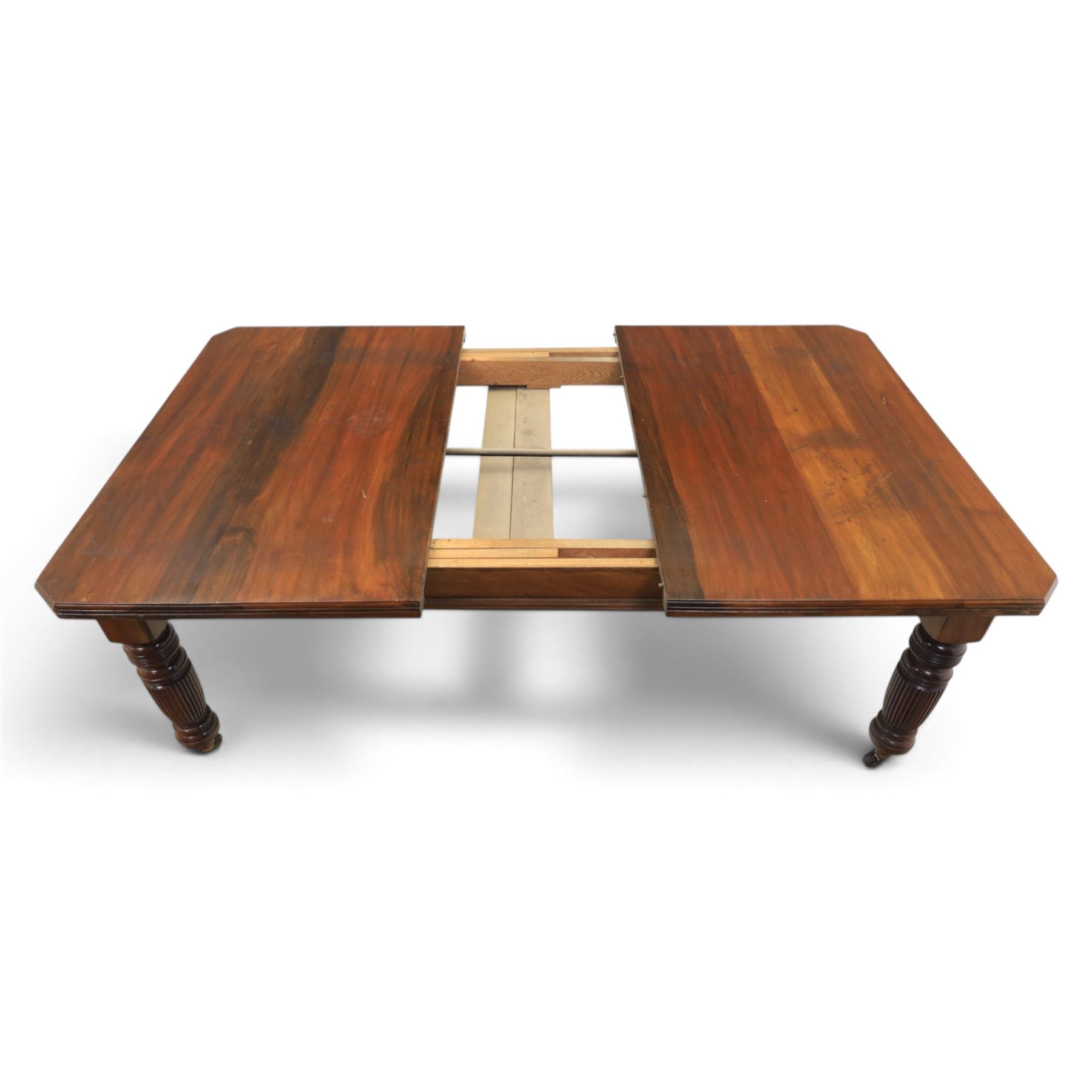 Victorian mahogany extending dining table and four chairs, rectangular top with moulded edge, extended to 198cm with additional leaf and winder, fluted and turned supports raised on castors, the chairs with swept frame and overstuffed seat, raised on cabriole front supports