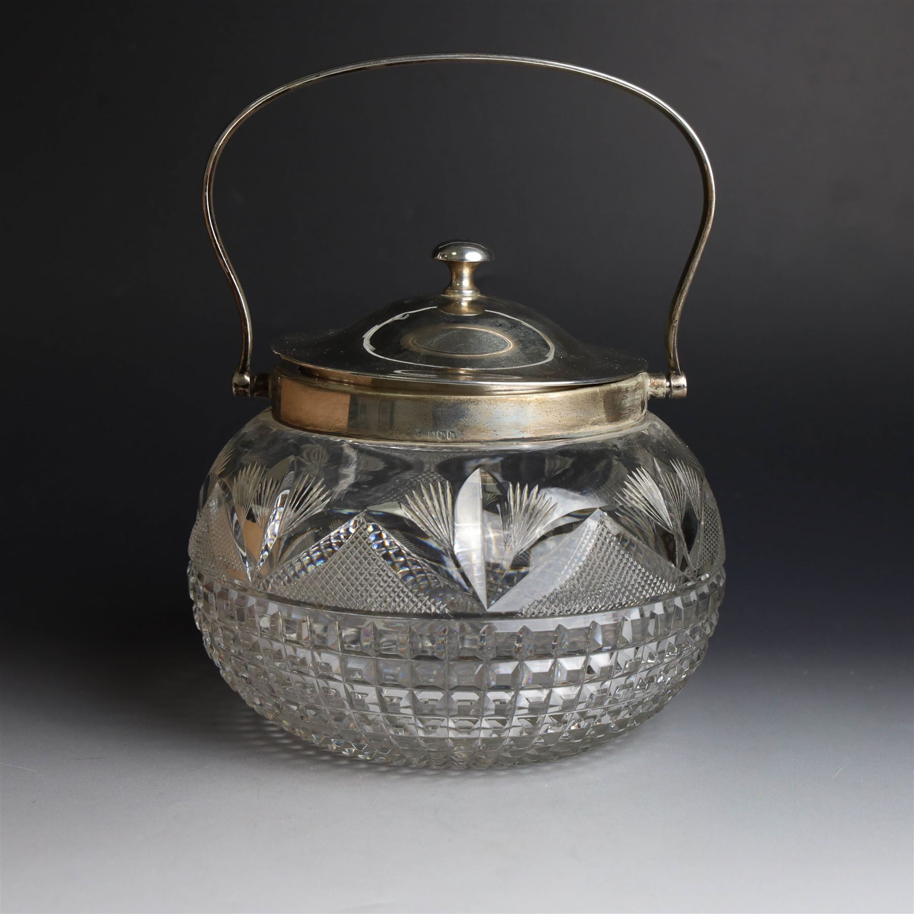 1920s silver mounted cut glass biscuit barrel, the ovoid glass body with square and hobnail cut decoration, with silver lid, collar and swing handle, hallmarked Cooper Brothers & Sons Ltd, Sheffield 1925, H15cm