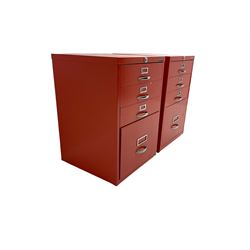 Two red finish 'Bisley' four drawer filing cabinet
