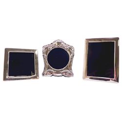 Three modern silver mounted photograph frames, comprising an example in the Art Nouveau style, of shaped form detailed with foliate tendrils, hallmarked Carr's of Sheffield Ltd, Sheffield 1992, overall H16cm W13.5cm aperture D9cm, a plain rectangular example, hallmarked Carr's of Sheffield Ltd, Sheffield 1989, overall H16cm W12cm aperture H12.5cm W8.5cm, and a plain square example, hallmarked Laurence R Watson & Co, Sheffield 1989, overall 11.5cm aperture 8.5cm, each with easel style support verso 