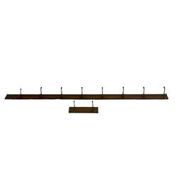 Late 19th century pitch pine wall hanging coat rail, fitted with metal hooks, two sections (longer section - L240cm; smaller section - 40cm)