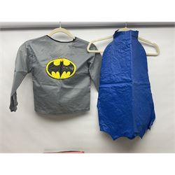 Two Boxed Batman Playsuit Costumes - 1960s 20th Century Original Play Suit, black eye mask, plastic vinyl cape/gauntlets, leather style belt, blue/yellow shirt, with Bat motif and blue/yellow pants; in original illustrated lidded box; and 1976 Decker Batman Playsuit costume, vinyl cape/ mask/gloves/boot tops/yellow belt, grey cloth top and pants; in original illustrated box (2)